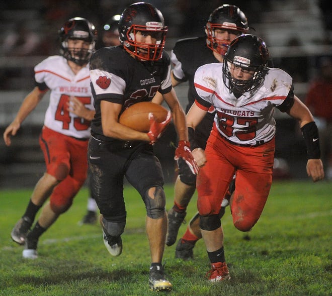 Crestview's Dylan Balcarcel (27) heads to the goal line in front of New London's Derek Smith (33) and Norbert Sword (45) at Crestview High School last week. The Cougars will try to extend their winning streak to three at South Central Friday night.