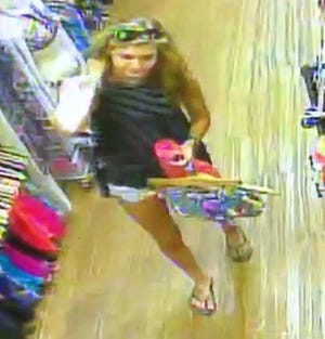 The Holland police department is seeking information about this woman's identity after she is suspected of stealing items from a downtown store. [Contributed]