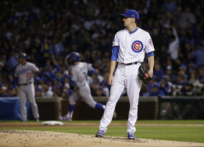 Los Angeles Dodgers' Chris Taylor (3) runs bases after hitting a home run as Chicago Cubs starting pitcher Kyle Hendricks reacts during the third inning of Game 3 of baseball's National League Championship Series, Tuesday, Oct. 17, 2017, in Chicago. (AP Photo/Nam Y. Huh)