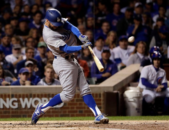 The Los Angeles Dodgers’ Chris Taylor hits a home run during the third inning of Game 3 of the NLCS against the Cubs on Tuesday in Chicago. The Dodgers won 6-1 to take a 3-0 series lead. (Matt Slocum/AP Photo)