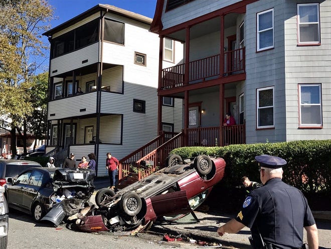 A car lies upside down on the sidewalk of Windsor Street in Worcester on Wednesday. [T&G Staff/Christine Peterson]