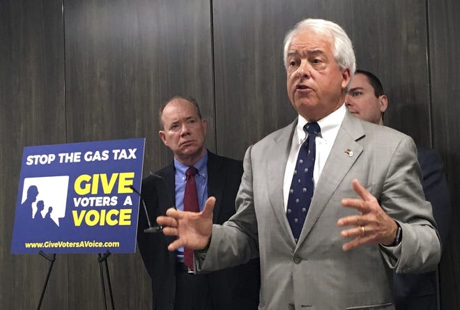 California Republican gubernatorial candidate John Cox, right, speaks in Sacramento on Wednesday about his decision to spend "significant" money on an effort to repeal California's newly passed gas and diesel tax increase. Cox is joined by Jon Coupal, president of the Howard Jarvis Taxpayers Association, at left. [Kathleen Ronayne, Associated Press]