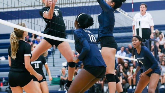 Vandegrift’s Annie Stadthaus tries to volley a shot over the net as Hendrickson’s Giselle German leaps to attempt a block during a nondistrict match in August. Stadthaus and the Vipers remain in the running for the District 25-6A championship. LOURDES M. SHOAF/FOR AMERICAN-STATESMAN