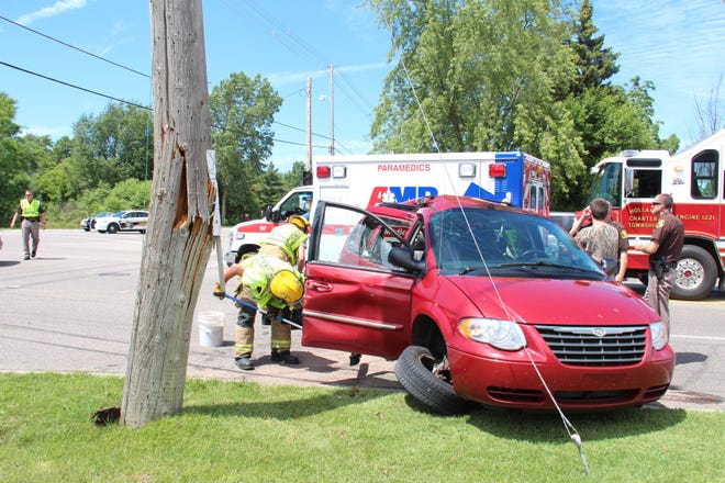 Michigan has had the highest auto insurance rates in the county the past four years. Crews clean up after a crash on Waverly Road in Holland on June 23, 2017 [Jake Allen/Sentinel]