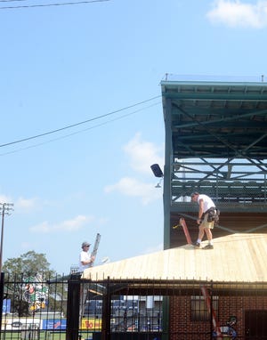 Byrd Construction workers install a wooden roof over the concession seating area Wednesday construction. [File Photo, Janet S. Carter / The Free Press]