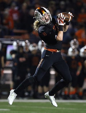 Massillon receiver Austin Kutscher catches a pass from quarterback Aidan Longwell that turned into a first-quarter touchdown during the Tigers' 35-6 win against Firestone last week. (IndeOnline.com / Kevin Whitlock)
