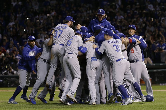 The Los Angeles Dodgers players celebrate after Game 5 of the National League Championship Series against the Chicago Cubs on Thursday in Chicago. The Dodgers won 11-1 to win the series and advance to the World Series. [Nam Y. Huh/The Associated Press]
