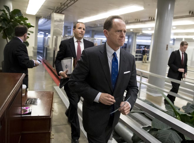 Sen. Pat Toomey, R-Pa., a member of the Senate Budget Committee, heads to the floor during a series of votes at the Capitol in Washington, Thursday, Oct. 19, 2017. (AP Photo/J. Scott Applewhite)