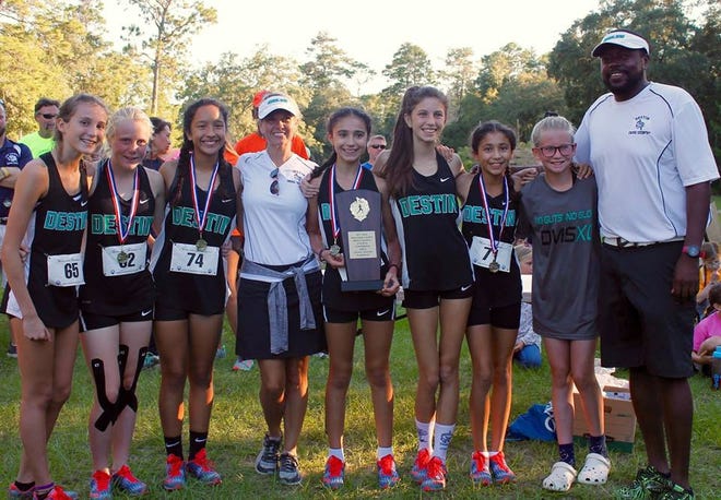 Showing off their second place trophy from the county cross country meet are members of the Desitn Marlin team. Pictured (from left) are Sara Crews, Kida Bailey, Nia Madrigal, Coach Tina Barron, Emily Kellogg, Abigail Kline, Sophia Kellogg, Katie Gilbert and Coach Demetrius Stevens. [SPECIAL TO THE LOG]