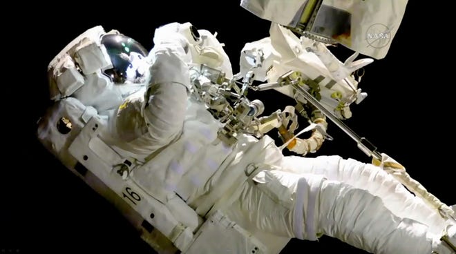 In this image from video made available by NASA, astronaut Joe Acaba performs a spacewalk outside the International Space Station on Friday, Oct. 20, 2017. Acaba was barely outside an hour when he had to replace one of his safety tethers. Spacewalking astronauts always have more than one of these crucial lifelines in case one breaks. They also wear a jetpack in case all tethers fail and they need to fly back to the space station. (NASA via AP)