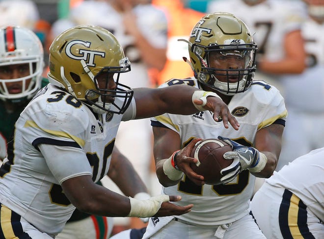 Georgia Tech quarterback TaQuon Marshall, right, fakes a handoff to running back KirVonte Benson (30) during the Oct. 14 game game against Miami in Miami Gardens, Fla. (Wilfredo Lee/AP Photo)