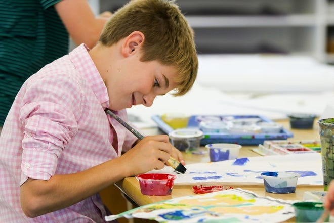 Grade 5 Derby Academy student Cole Daniello, of Cohasset, works on a 42-foot painted mural inspired by the lyrics to "America the Beautiful," on Tuesday, October 2 at Derby Academy in Hingham. Derby plans to hang the mural on the stone wall in front of the Old Ship Church in preparation for the Hingham Arts Walk in downtown Hingham on October 22. [Courtesy Photo]
