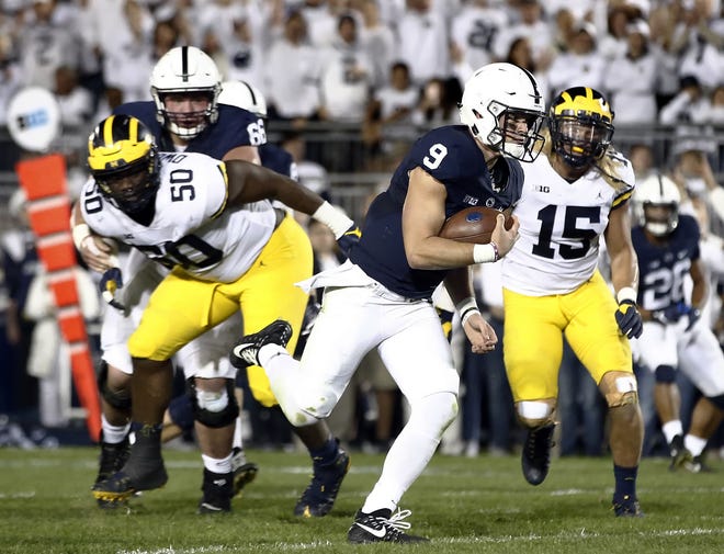 Penn State quarterback Trace McSorley (9) runs in for a touchdown against Michigan during the first half of an NCAA college football game in State College, Pa., Saturday, Oct. 21, 2017. (AP Photo/Chris Knight)