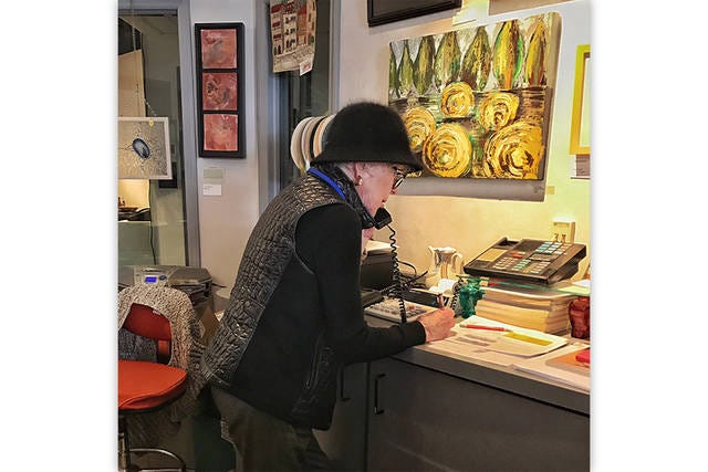 ENCOURAGER-IN-CHIEF — Artist Starr Ayers captures Claudia Ainsworth at work in Morings, the gift shop of the Randolph Arts Guild. For two decades, she uplifted the artists, would-be artists, customers, friends and strangers who walked through the doors. (Contributed)