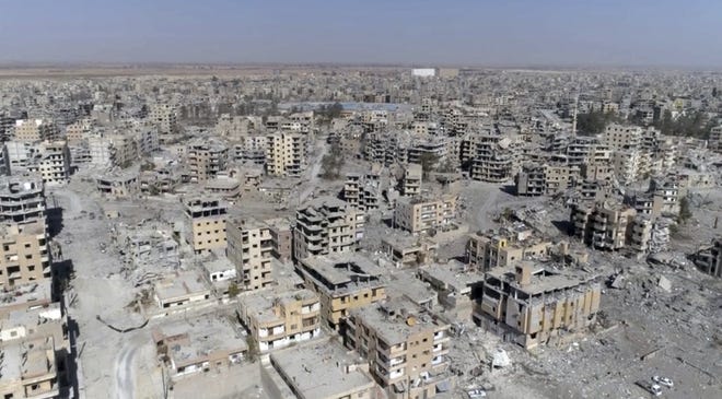 This Thursday, Oct. 19, 2017 frame grab made from drone video shows damaged buildings in Raqqa, Syria, two days after Syrian Democratic Forces said that military operations to oust the Islamic State group have ended and that their fighters have taken full control of the city. (AP Photo/ Gabriel Chaim)