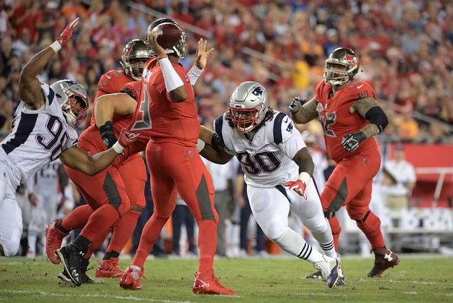 Tampa Bay Buccaneers quarterback Jameis Winston (3) is pressured by New England Patriots defensive end Trey Flowers (98) and defensive tackle Malcom Brown (90) during the first half of an NFL football game Thursday, Oct. 5, 2017, in Tampa, Fla. (AP Photo/Phelan M. Ebenhack)