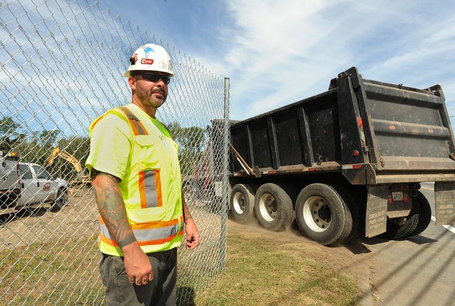 Cardi Corp. foreman Richard Matthews keeps a watchful eye on traffic after waving a dump truck through the opening to the casino entrance in August.