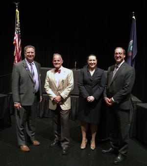 Allegan County Sheriff Frank Baker (from left), Judge William Baillargeon, Prosecuting Attorney Jessica Winsemius and Defense Attorney Matt Antkoviak stand in front of their makeshift court at Fennville High School. Court was held at the high school so students could experience the judicial system. [Contributed]