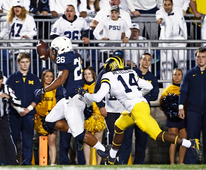 Penn State's Saquon Barkley (26) scores a touchdown as Michigan's Josh Metellus (14) tries to chase him down during the first half of an NCAA college football game in State College, Pa., Saturday, Oct. 21, 2017. (AP Photo/Chris Knight)