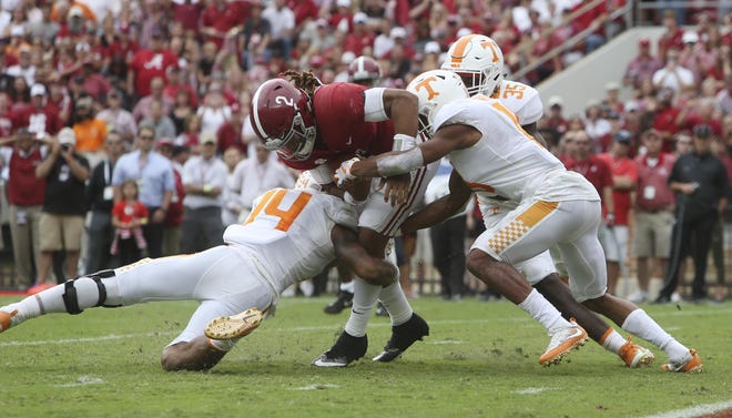 Alabama quarterback Jalen Hurts (2) is brought down by Tennessee linebacker Quart'e Sapp (14) and Tennessee defensive back Nigel Warrior (18) just short of the end zone during the first half of the Tennessee game at Bryant-Denny Stadium in Tuscaloosa on Saturday, Oct. 21, 2017.  [Staff Photo/Erin Nelson]