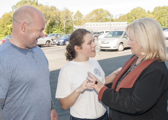 Student Grace Felter, 14, tells Higashi School Principal Deborah Donovan, and Teamsters Local 25 President Sean O'Brien all about her three-mile run during the school daily road race around the property. {Wicked Local photo/Bob Michelson]