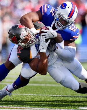 Buffalo's Preston Brown (52) tackles Tampa Bay's Doug Martin during the first half Sunday in Orchard Park, New York. [Associated Press/Rich Barnes]