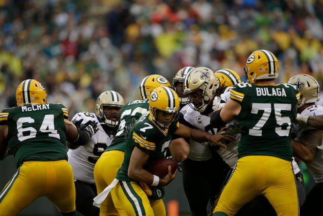 Green Bay Packers quarterback Brett Hundley (7) tries to run from New Orleans Saints defense during the second half of an NFL football game, Sunday, Oct. 22, 2017, in Green Bay, Wis. (AP Photo/Jeffrey Phelps)