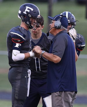 Fairless head coach Don Wilson talks with quarterback Jack Laney during their season opener against Sandy Valley. 

(IndeOnline.com / Kevin Whitlock)