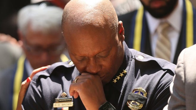 Dallas Police Chief David Brown pauses at a prayer vigil after five officers were killed during a July 2016 Black Lives Matter march. The deaths helped inspire a proposed amendment to the Texas Constitution to offer property tax breaks to the spouses of first responders killed on duty. SPENCER PLATT / GETTY IMAGES
