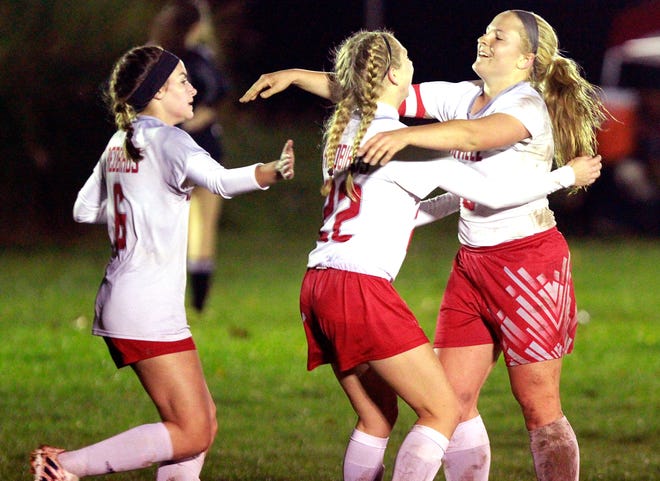 Loudonville's Stephanie Kline (center) celebrates her first half goal with Nikki Weber (right) and Karli Shriver against Manchester during a Div. III Medina District semifinal Monday. The host Redbirds advanced with a 3-0 shutout of the Panthers.