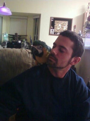 Gerald "Jerry" Breen with Chico, the blue-and-gold macaw. [CONTRIBUTED PHOTO]