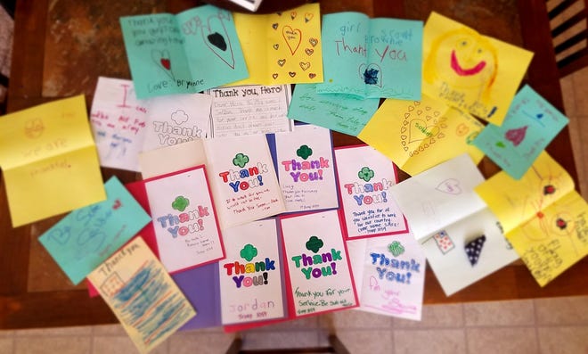 Thank-you notes from local Girl Scout troops are shown above. These letters, along with care kits from Operation Gratitude and boxes of Girl Scout cookies, have been hand-delivered to first responders and law enforcement in the area. [Photo courtesy of Lorraine McGowan]