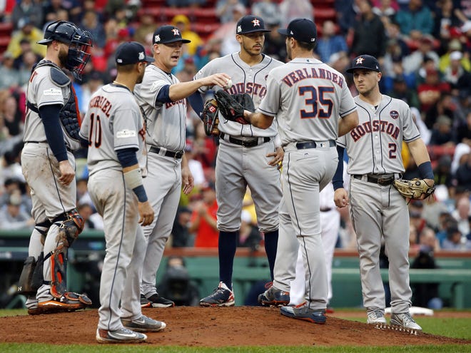 Houston Astros manager A.J. Hinch, third from left, gives the ball to pitcher Justin Verlander (35) for his first Major League relief appearance during the fifth inning in Game 4 of an American League Division Series against the Boston Red Sox on Oct. 9 in Boston. [AP Photo / Michael Dwyer, File]