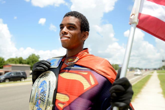 Raeshorn Pitt dressed as Superman and waved to drivers passing along East Washington Street on July 10 in Minneola. [DAILY COMMERCIAL FILE]