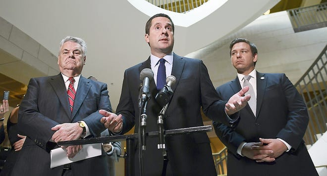 House Intelligence Committee Chairman Rep. Devin Nunes, R-Calif., center, standing with Rep. Peter King, R-N.Y., left, and Rep. Ron DeSantis, R-Fla., right, speaks on Capitol Hill in Washington Tuesday. [SUSAN WALSH/ASSOCIATED PRESS]