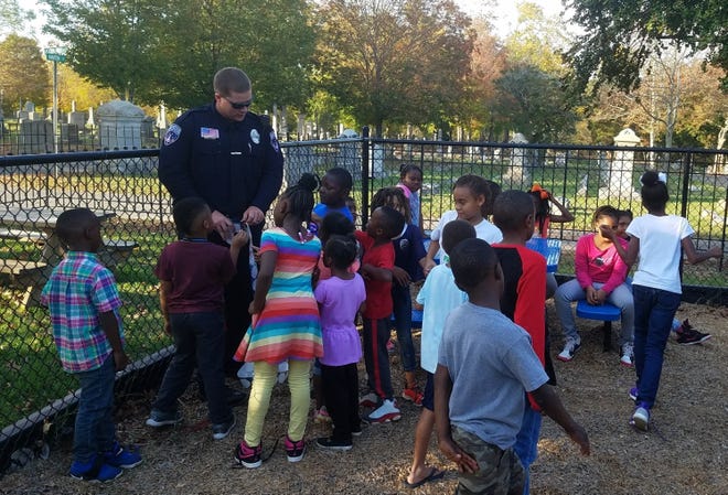 Students at the Boys & Girls Club of Cleveland County meet with an officer from the Shelby Police Department during last year's Lights On Afterschool event. [Special to The Star]