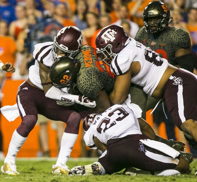 Florida running back Lamical Perine is brought down by Texas A&M defenders in the Oct. 14 game at Ben Hill Griffin Stadium. Part of the Gators work since the SEC loss is improving fourth-quarter production. [Cyndi Chambers/Correspondent]