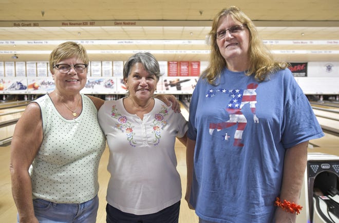 Gena Jones, from left, Sharon August and Liz Olson pose at Break Point Alley in Tavares. The three women and Verna Davis teamed up over the summer to win the Midwest Ladies Bowling Tournament. [PAUL RYAN / CORRESPONDENT]