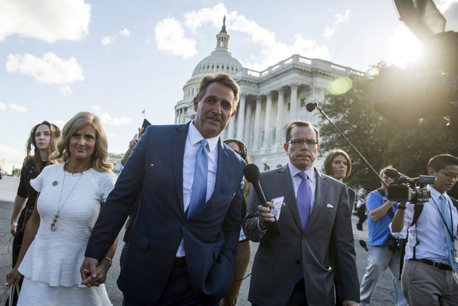 Sen. Jeff Flake, R-Ariz., accompanied by his wife Cheryl, leaves the Capitol in Washington, Tuesday, Oct. 24, 2017, after announcing he won't seek re-election in 2018. (AP Photo/Andrew Harnik)