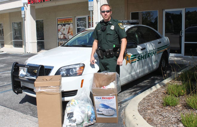 Flagler County Sheriff's Office Sgt. Daniel Weaver manned the Palm Coast precinct drop-off site during a previous Take Back Prescription Drugs Initiative. Flagler County residents will have an opportunity to discard unused and expired medications safely during National Prescription Drug Take-Back Day from 10 a.m. to 2 p.m. Saturday at four locations across the county. [News-Tribune file]