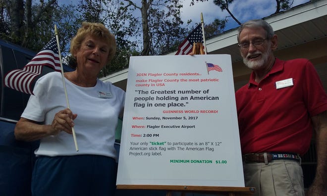 Nikki and Larry White, founders of The American Flag Project, are hoping people will join them Nov. 5 at the Flagler Executive Airport to wave their flags and show their patriotism. [News-Tribune/Shaun Ryan]