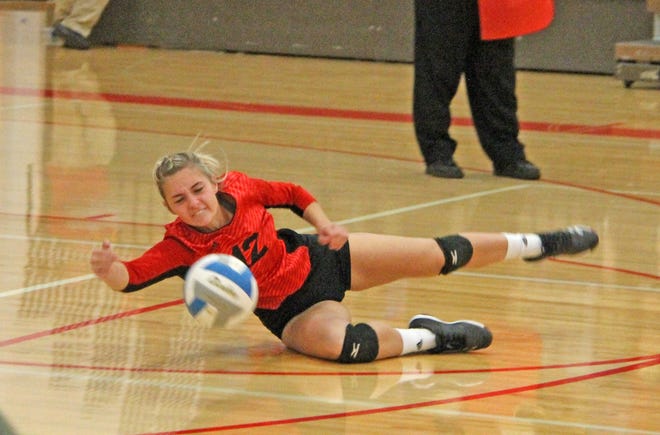 Coldwater's Carlie Wilson (12) goes all out as she dives for a dig Wednesday versus Hastings. TROY TENNYSON PHOTO