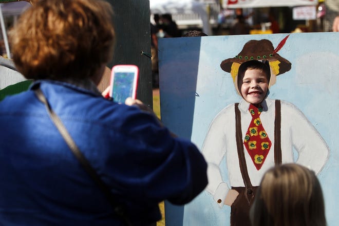 Teresa Wruck takes a photo of her grandson, Cole Hill, 6, during Onslow Oktoberfest at Riverwalk Park in downtown Jacksonville in 2015. [Daily News file photo]