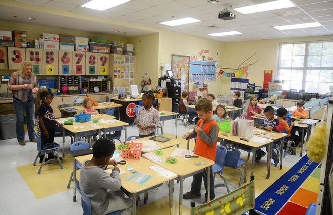 Students do classwork in Helen Lewis's first grade class Wednesday at Pink Hill Elementary School. [Janet S. Carter / The Free Press]
