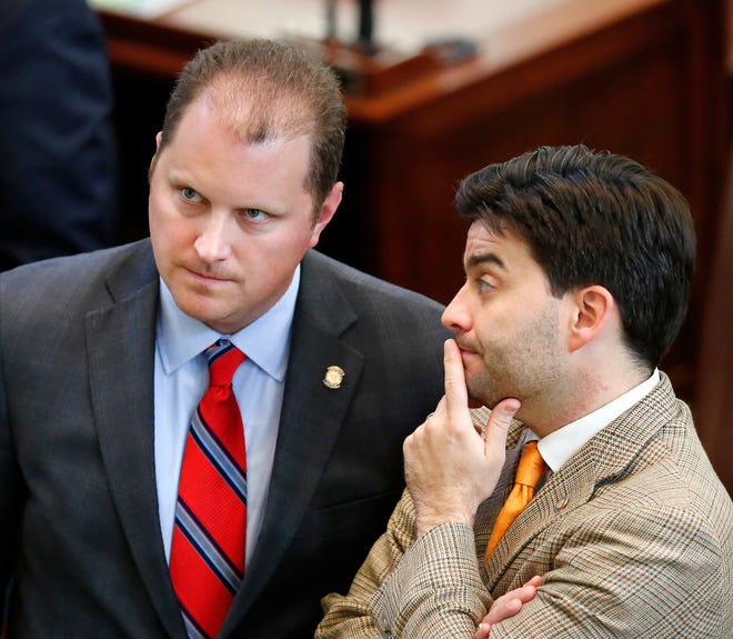 House Majority Floor Leader Jon Echols, left, looks up at the vote tally board while he talks to state Rep. Eric Proctor on the House floor this week. Photo by Jim Beckel