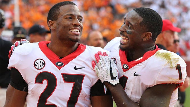 Georgia tailbacks Nick Chubb (27) and Sony Michel (1) celebrate on the sidelines during the fourth quarter of a 41-0 win against Tennessee on Sept. 30 at Neyland Stadium. (Curtis Compton/Atlanta Journal-Constitution)