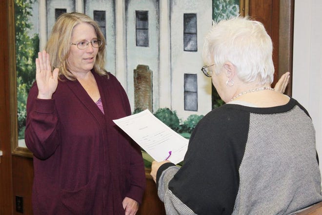 Avowed service Bradford resident Cynthia Eberle, left, officially is appointed to a seat on the Stark County Board after Stark County Clerk Linda Pyell delivers the oath of office.