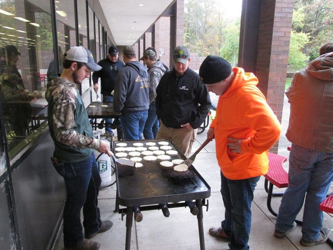 Students flip pancakes.
