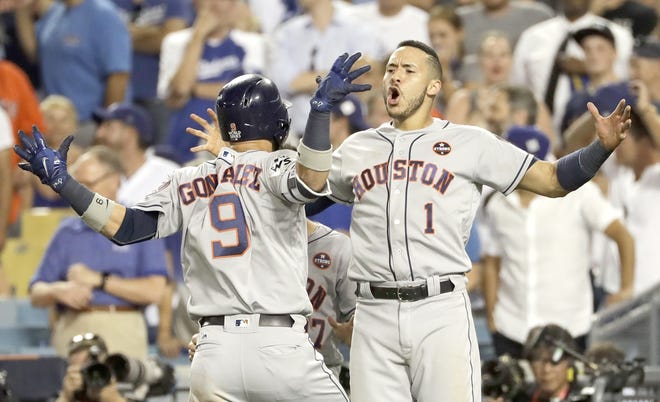 Houston Astro Marwin Gonzalez celebrates his home run with Carlos Correa (9) during the ninth inning of Game 2 of baseball's World Series against the Los Angeles Dodgers Wednesday in Los Angeles.      

[Matt Slocum / Associated Press]