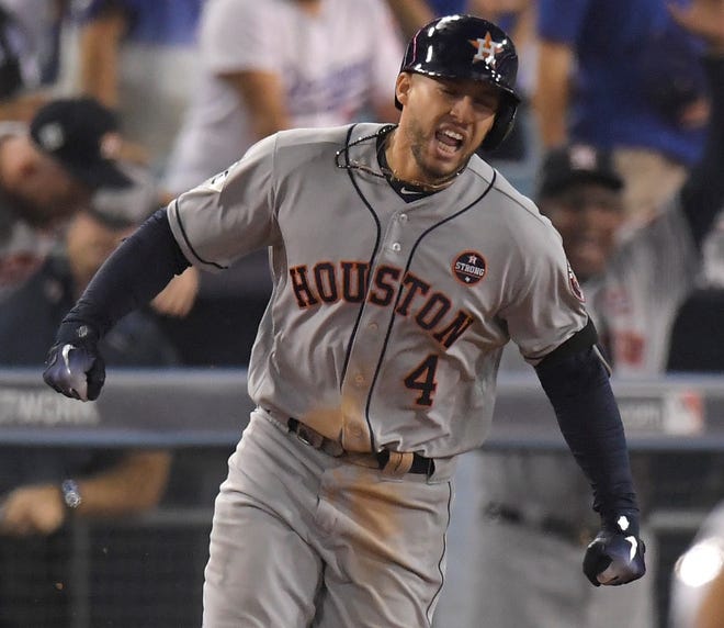 Houston Astros' George Springer celebrates after a home run against the Los Angeles Dodgers during the 11th inning of Game 2 of baseball's World Series Wednesday, Oct. 25, 2017, in Los Angeles. (AP Photo/Mark J. Terrill)
